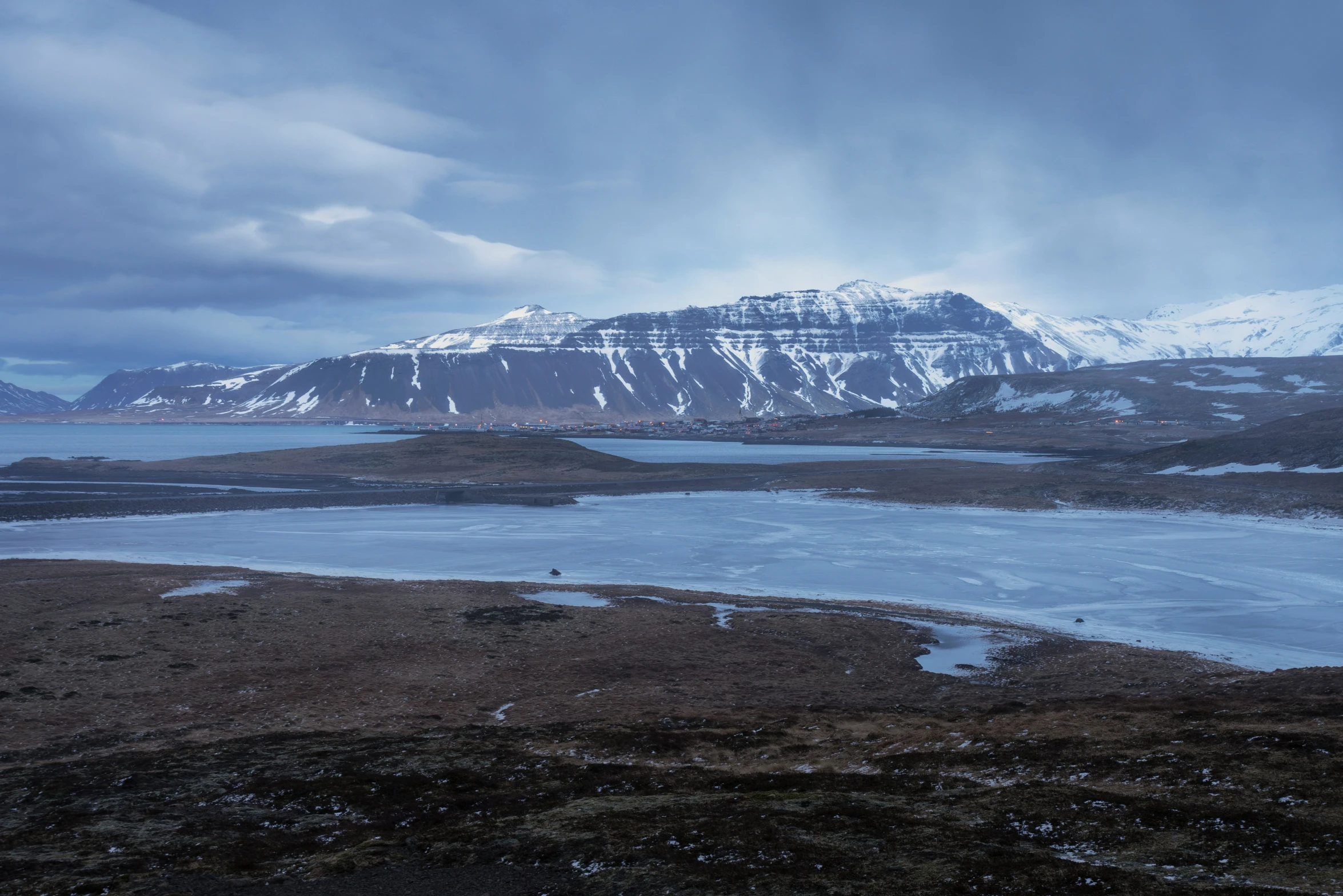 a mountain near the shore of water and land