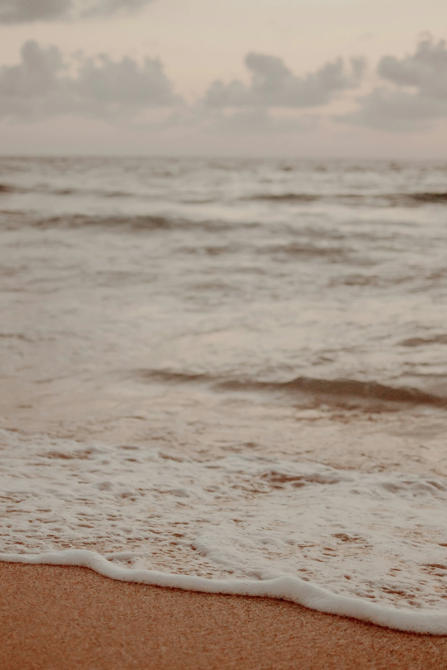 a beach with a few waves coming in