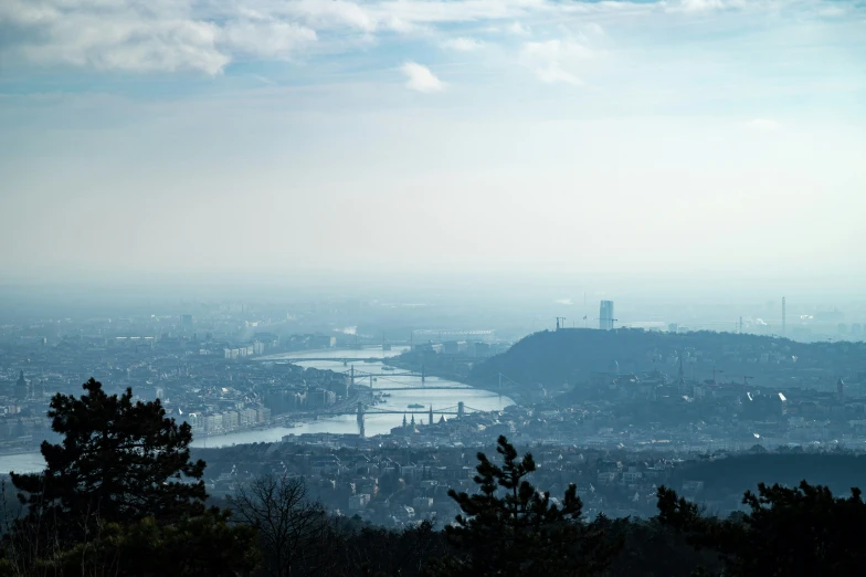 a city and river as seen from a hill top