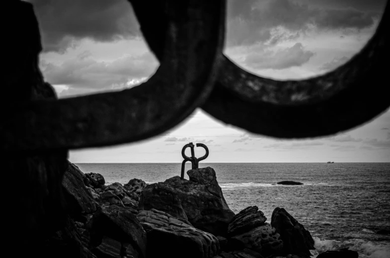 a rock outcropping and two metal circles that are on it