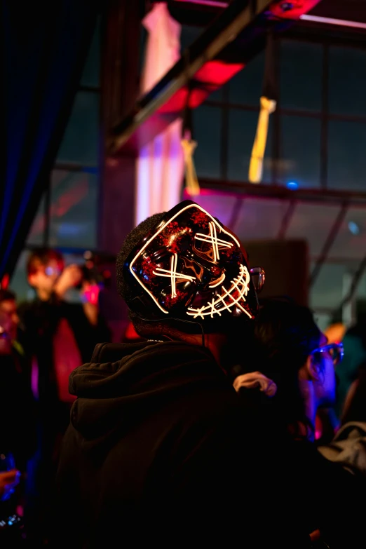 the person is wearing a mask that has been decorated with red lights