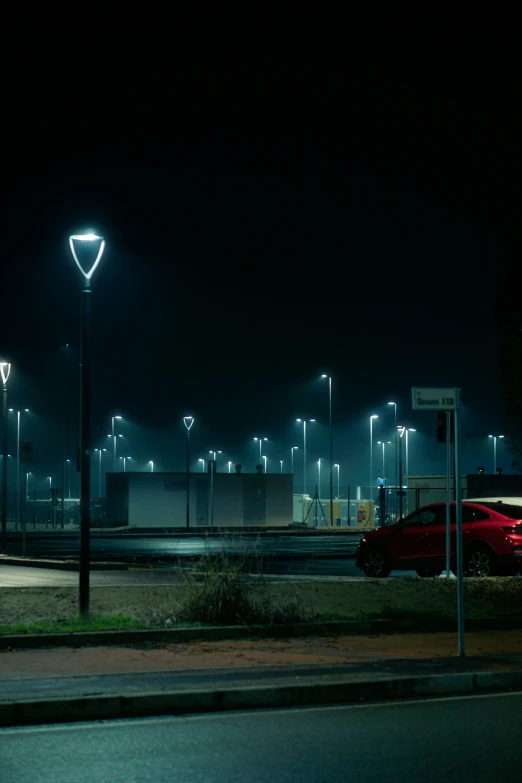 cars parked in front of a building at night