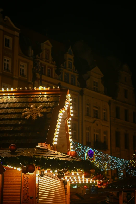 a dark background with lots of lights on a building