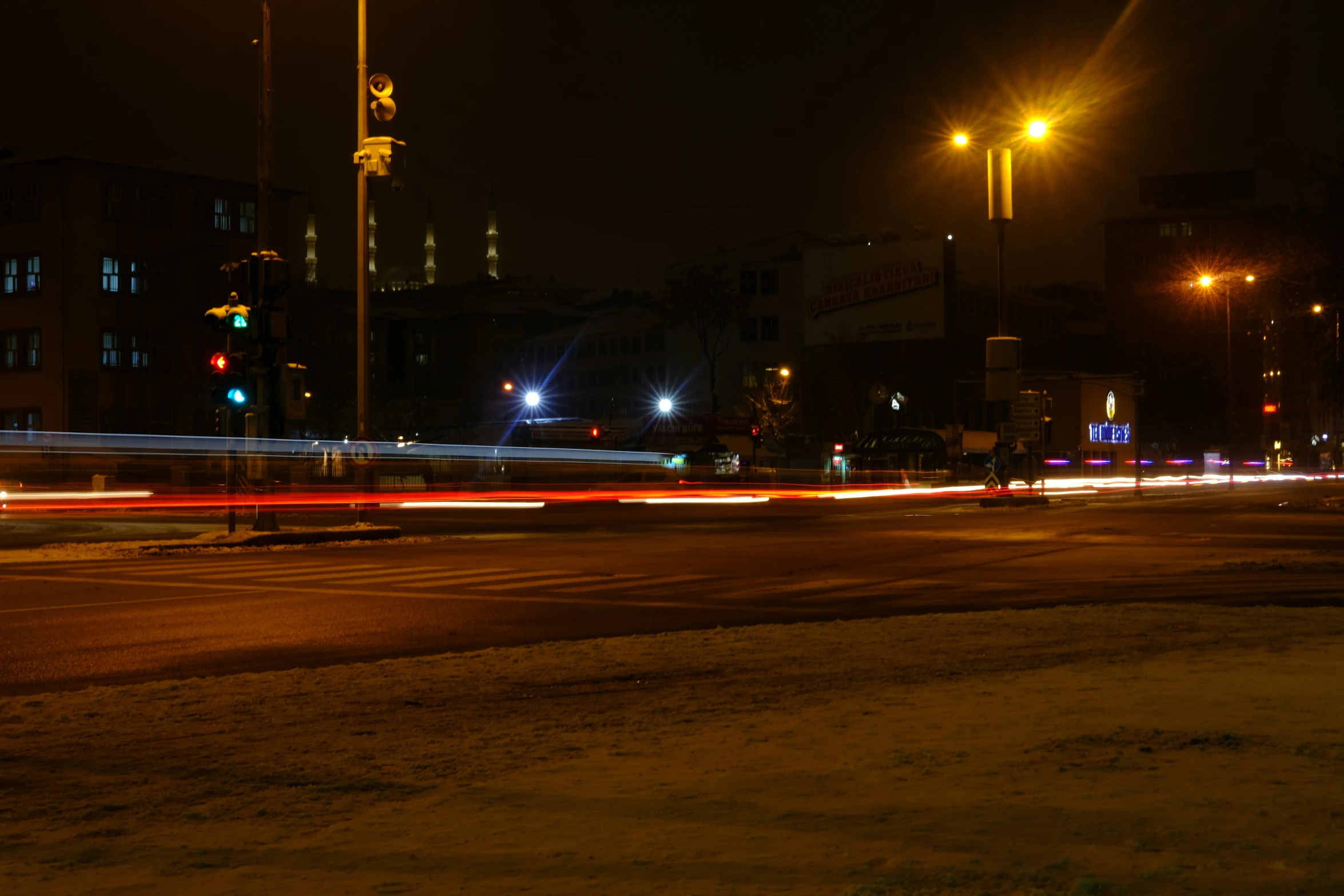 street lights in the distance with cars in the foreground