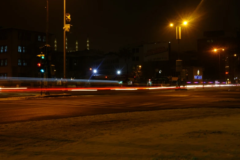 street lights in the distance with cars in the foreground