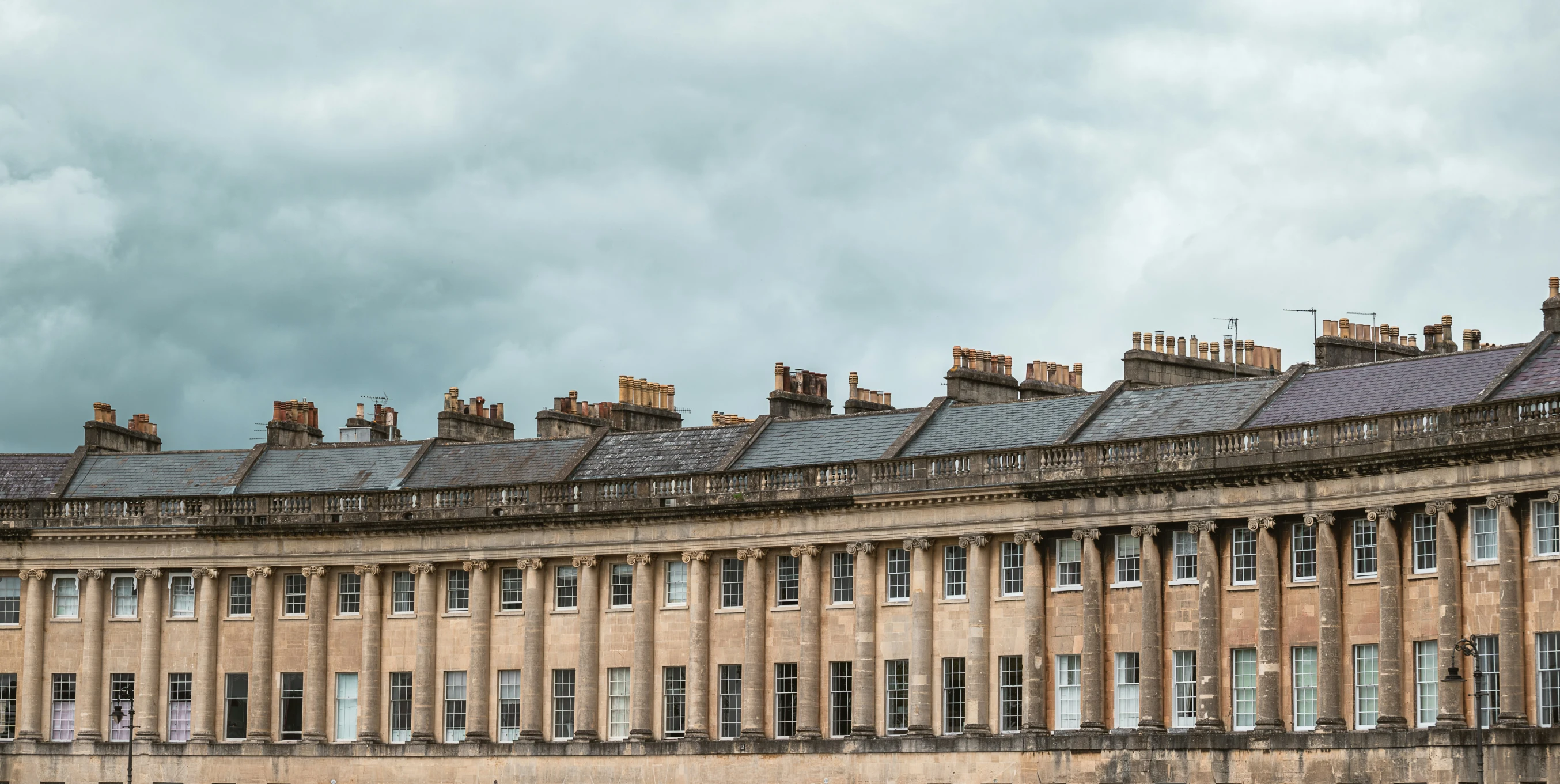 the facade of a mansion in england against a dark sky