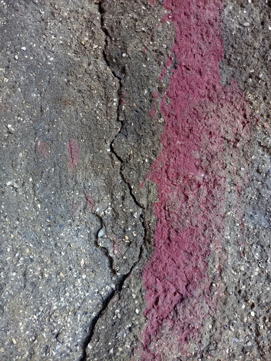 an image of red paint on the pavement