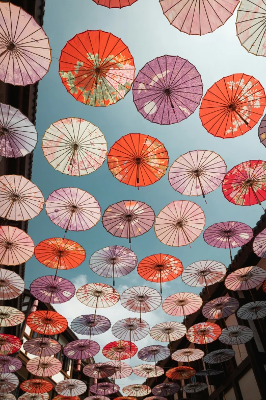 the view from below of a ceiling with umbrellas in the air