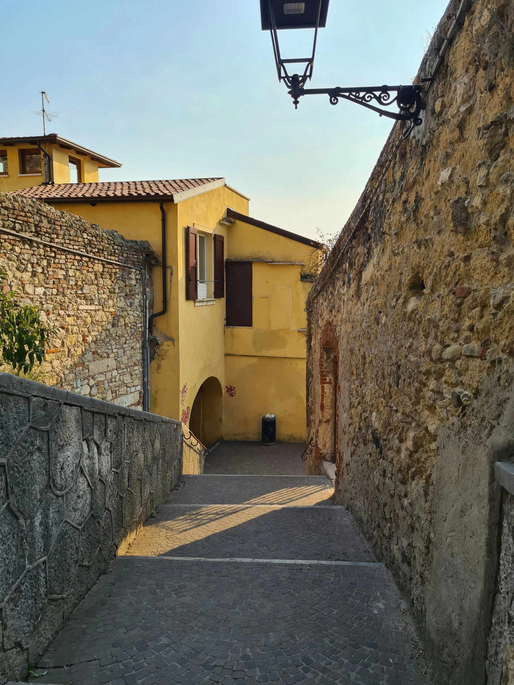 an alley way is leading up the hill