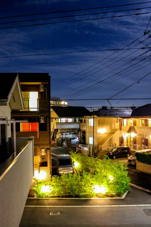 a city street at night with residential houses