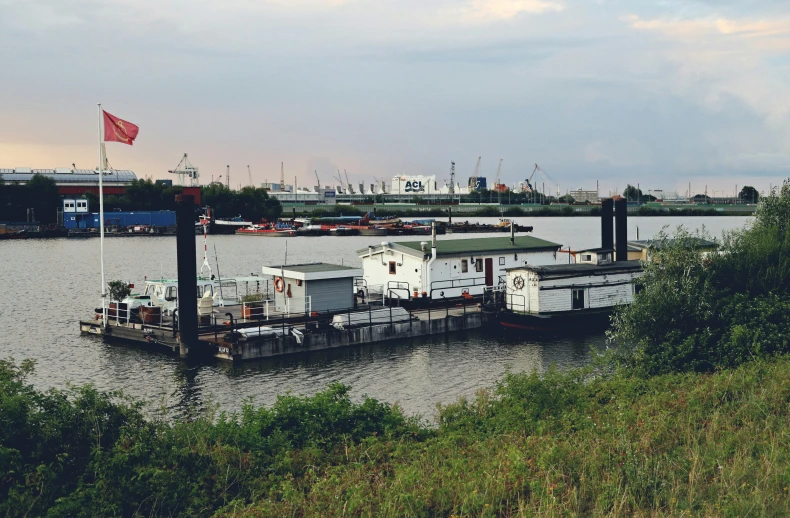 the barge is docked with several containers on it