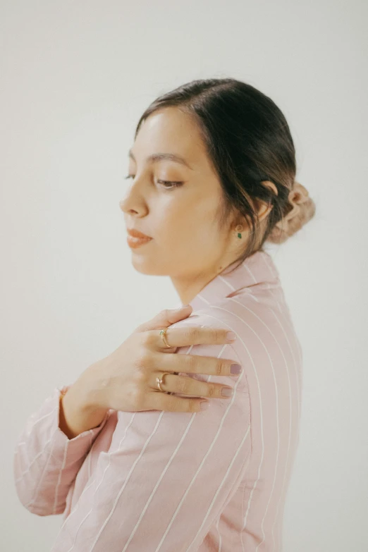 woman in a pink blouse with her hand on the shoulder