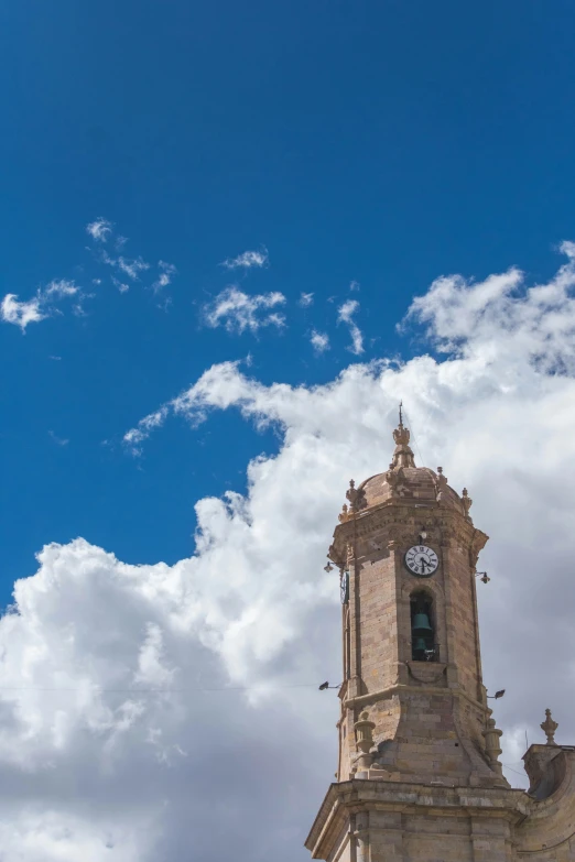 the clock tower stands tall as clouds hover overhead