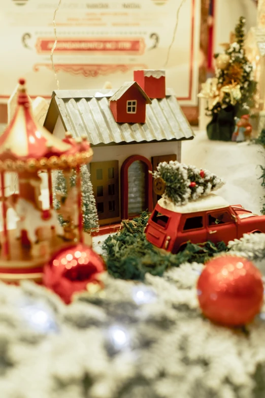 a christmas display with a white roof and holiday decorations