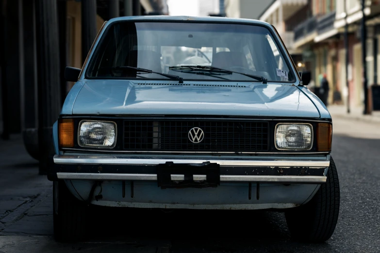 a volkswagen van with some license plates parked on the side of a street