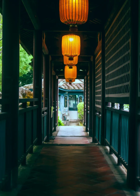 lanterns hanging in a hallway of an open building