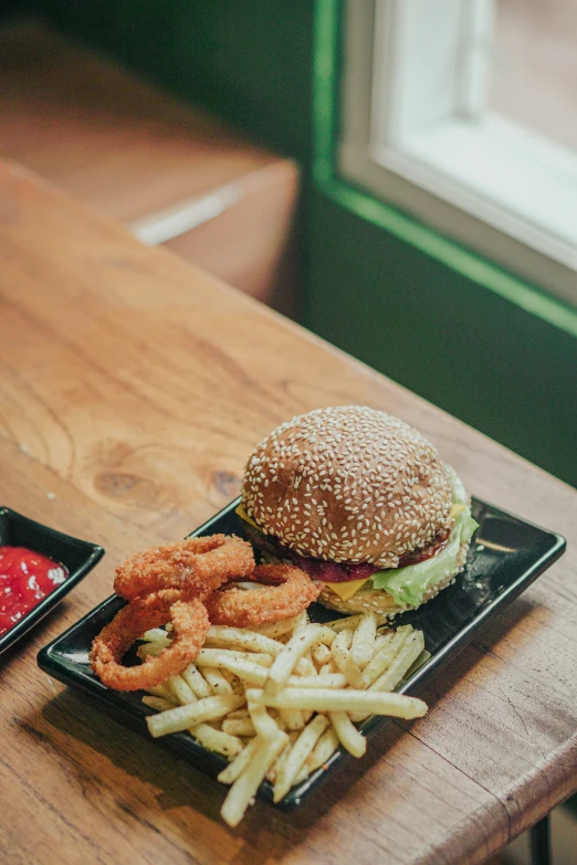 there is a hamburger and french fries on the table