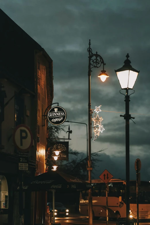 a street lamp with buildings in the background at night