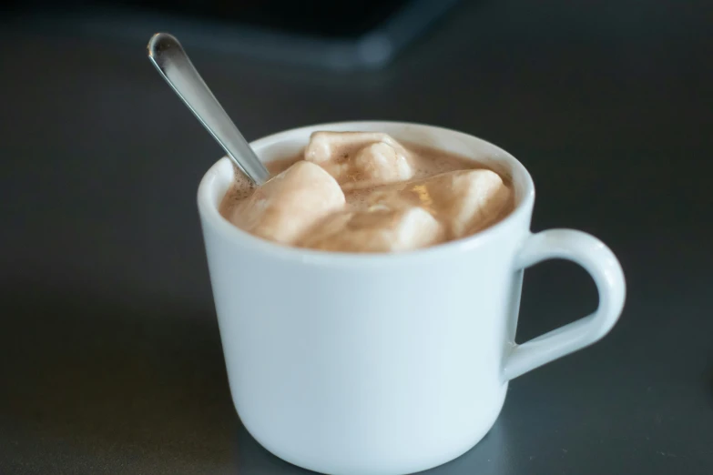 a white mug filled with ice cream on a table