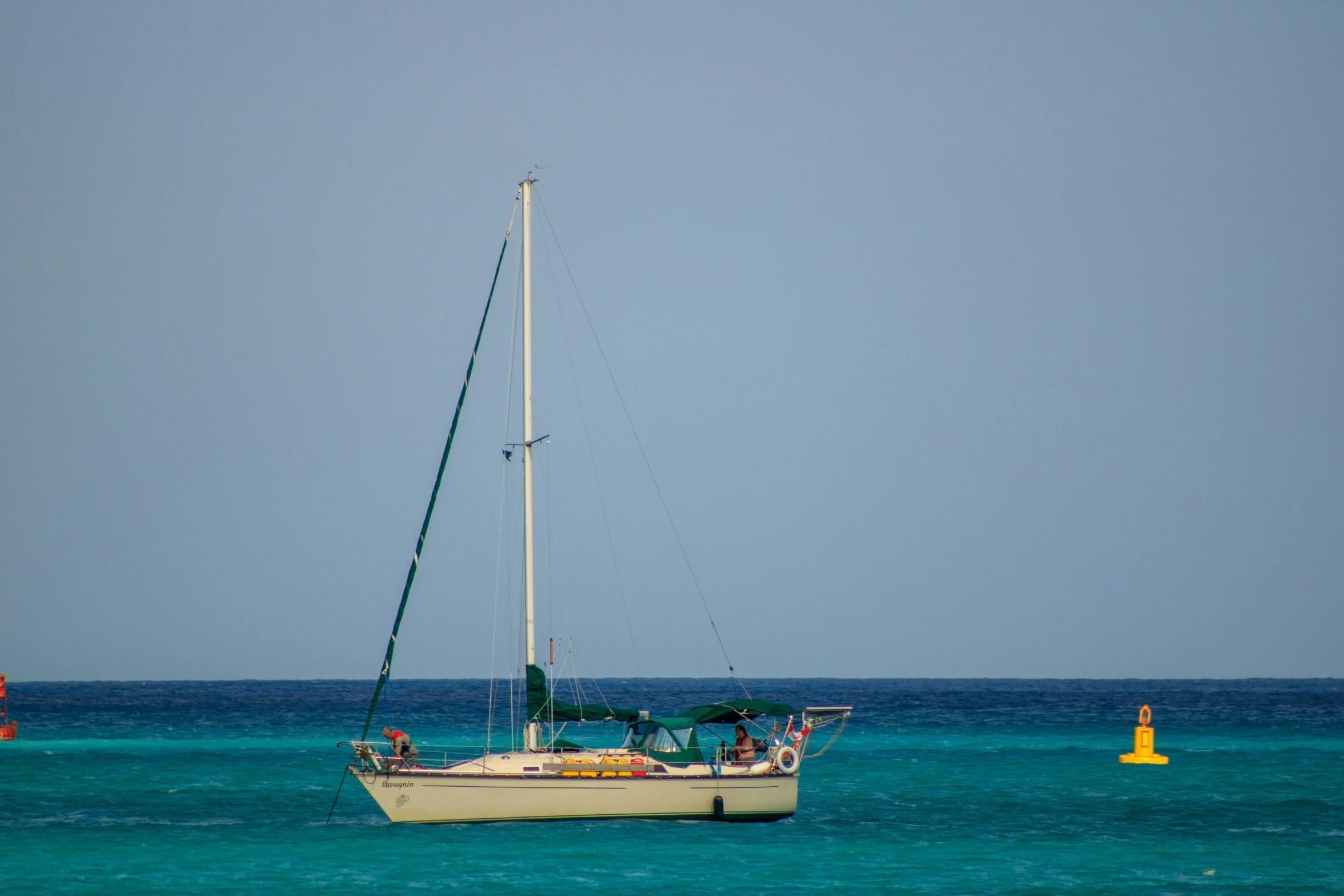 an sailboat floats in the open ocean