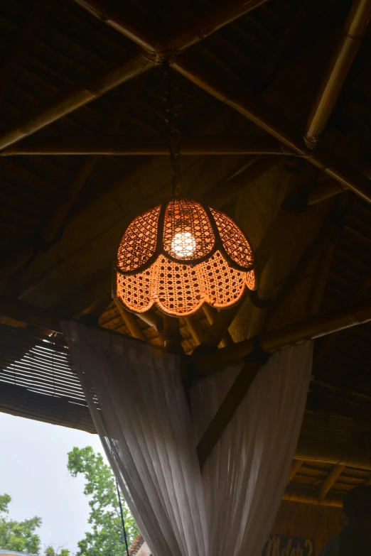 a large light hanging over a table with a cloth dd under it