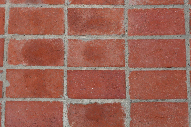red bricked area with cement on it and a piece of scissors