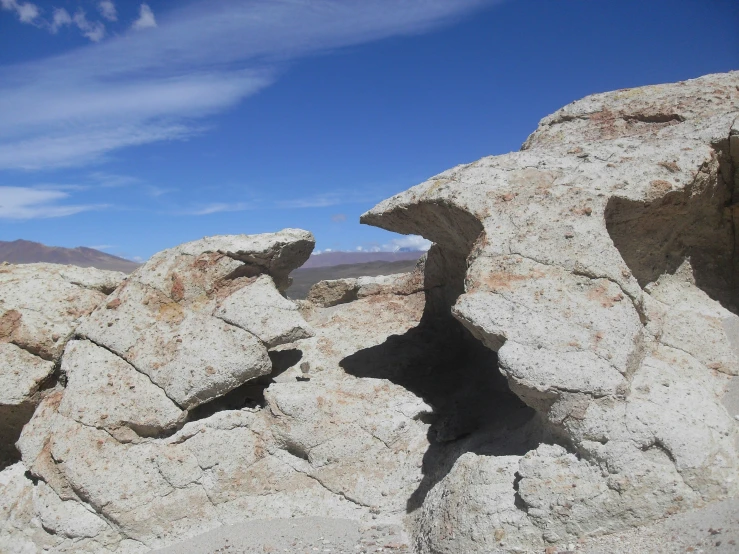 a rock formation with a view of the mountains in the background