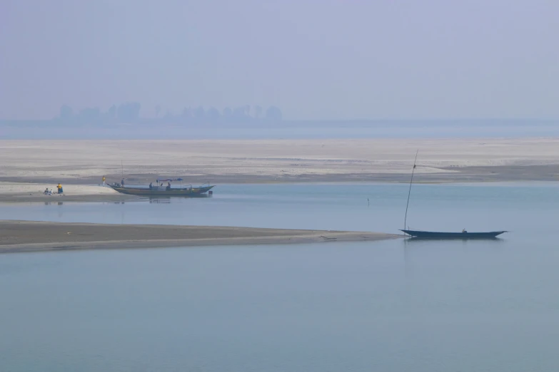 a boat sits in the water, on one side is another boat