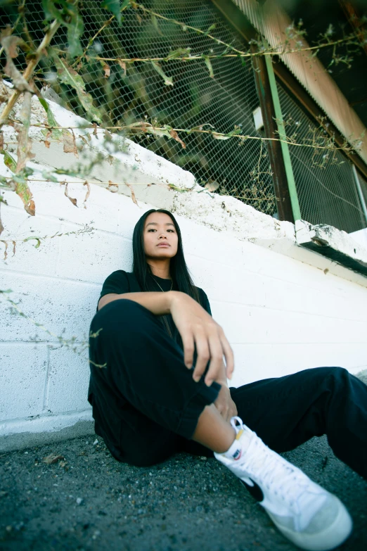 a woman sitting on the ground looking up