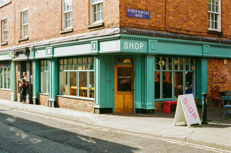 a street side walk with an old fashioned store front