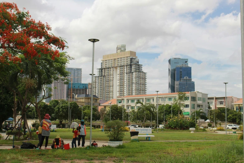 people with their luggage are in the park in the city