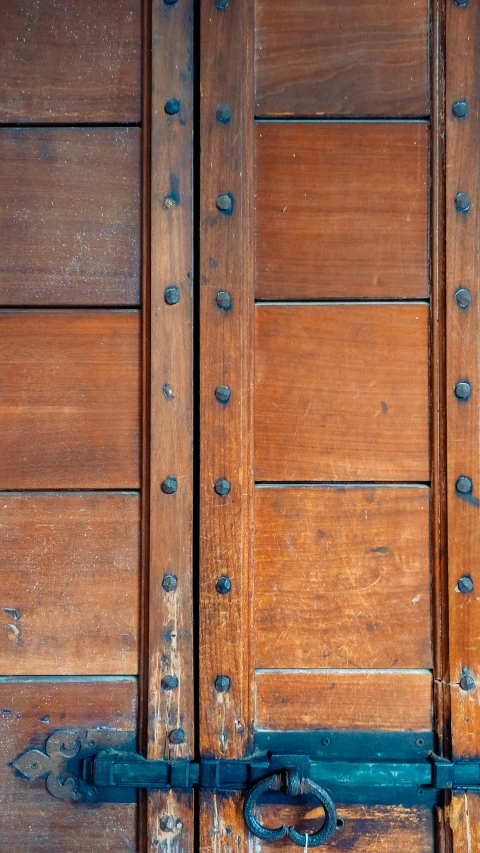 a pair of scissors is hanging on the old wooden door