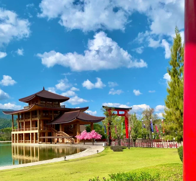 the chinese pavilion sits beside a water pond