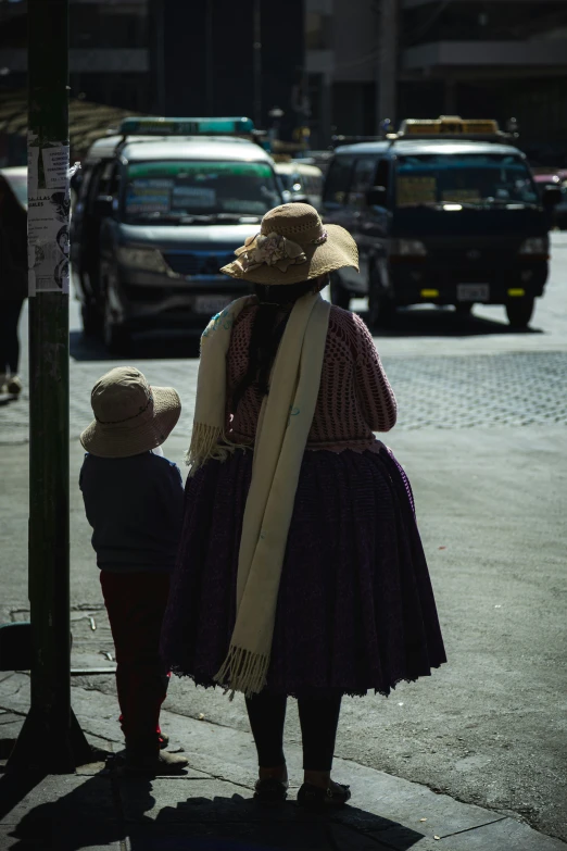 a woman and a child on the side of a road