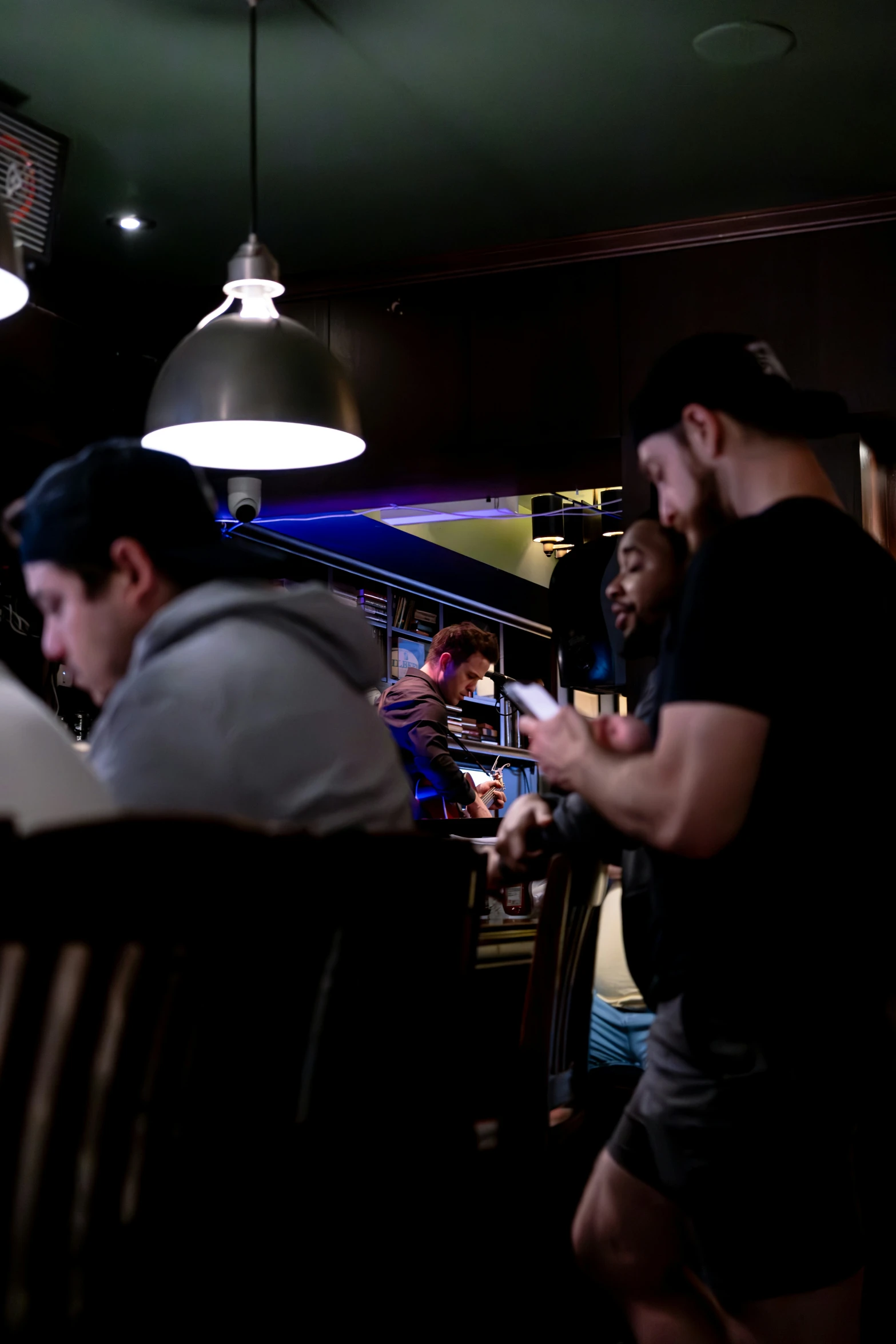 several men seated at a table in a restaurant