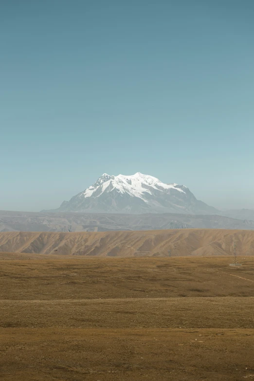 the mountain is covered in snow at the base of it