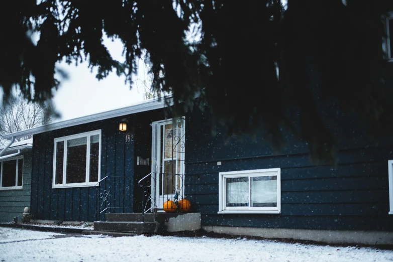 a house with a fall colored pumpkin in front of it