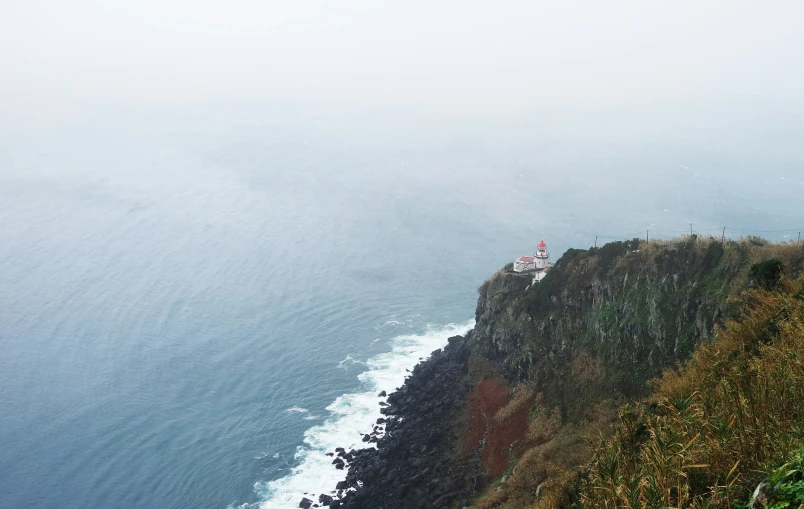 two lighthouses are at the top of the cliffs