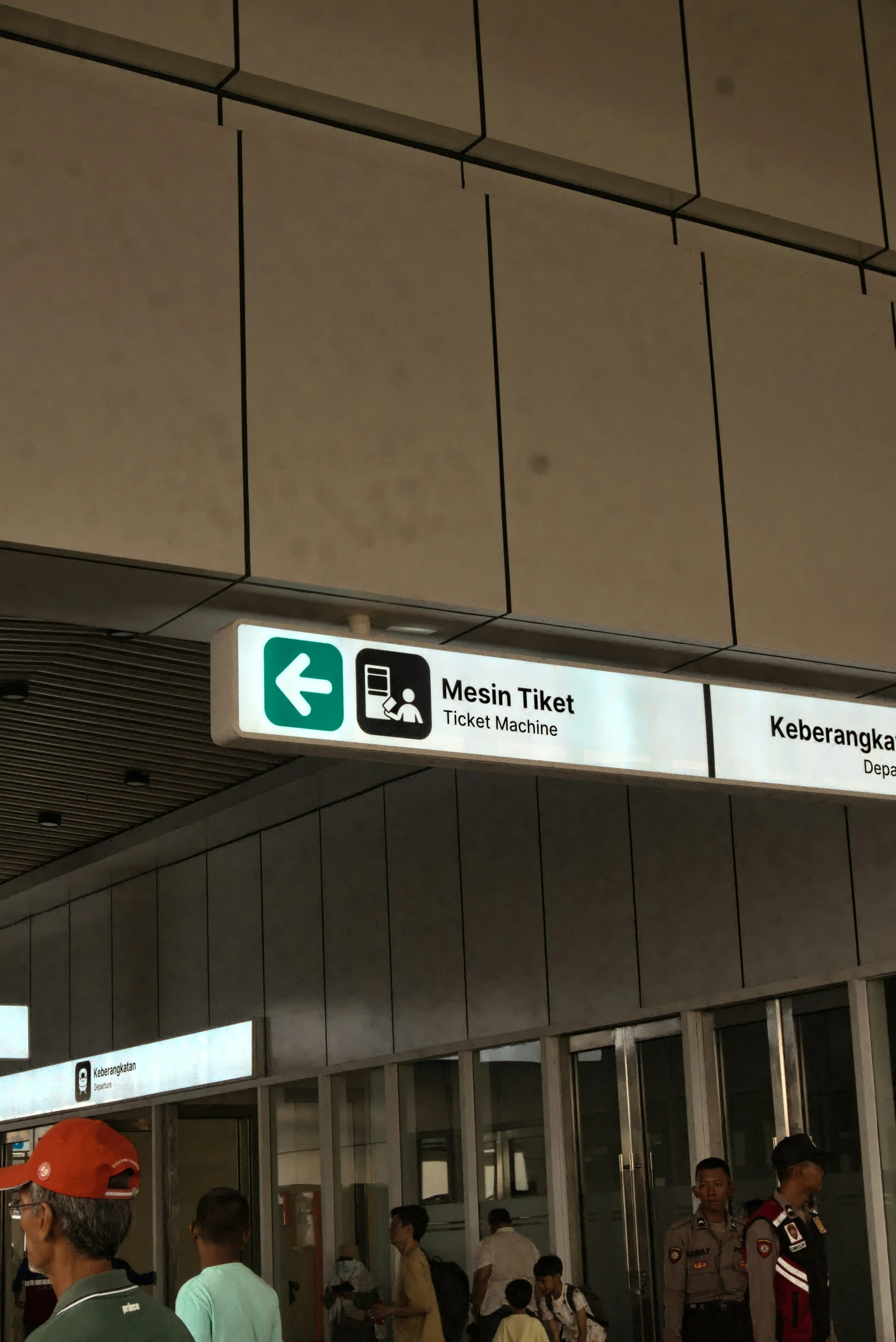 an airport terminal that has people at their baggage