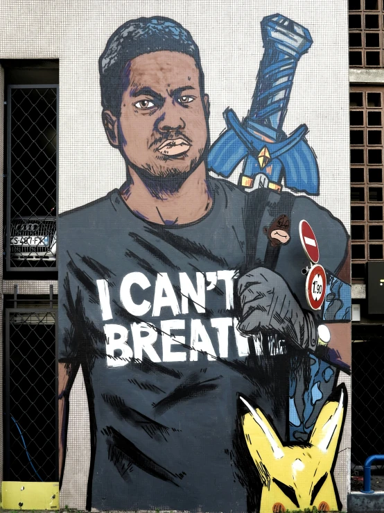 a man wearing a t - shirt next to a mural