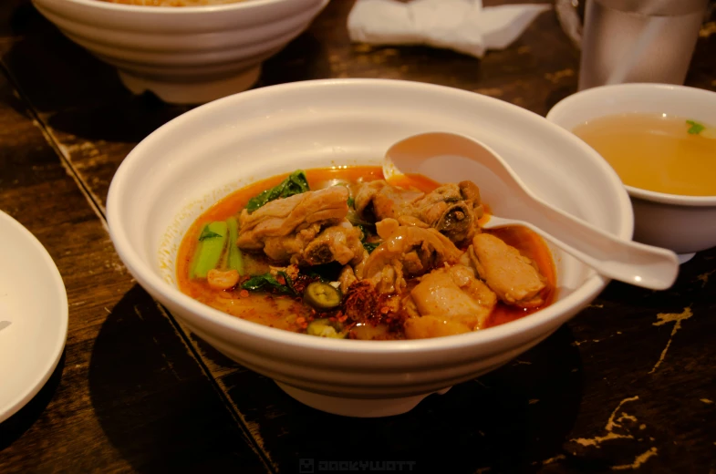 a small bowl with stew and soup on the side