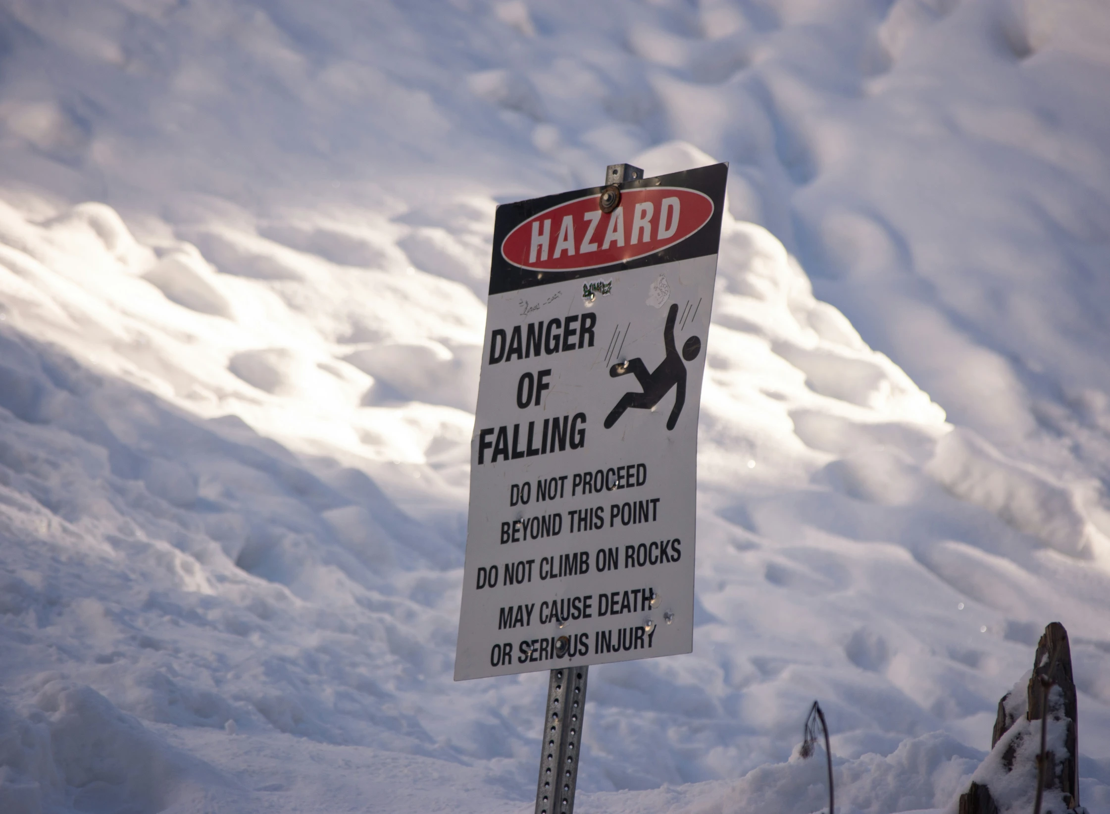 there is a sign on the side of the hill warns people to be careful