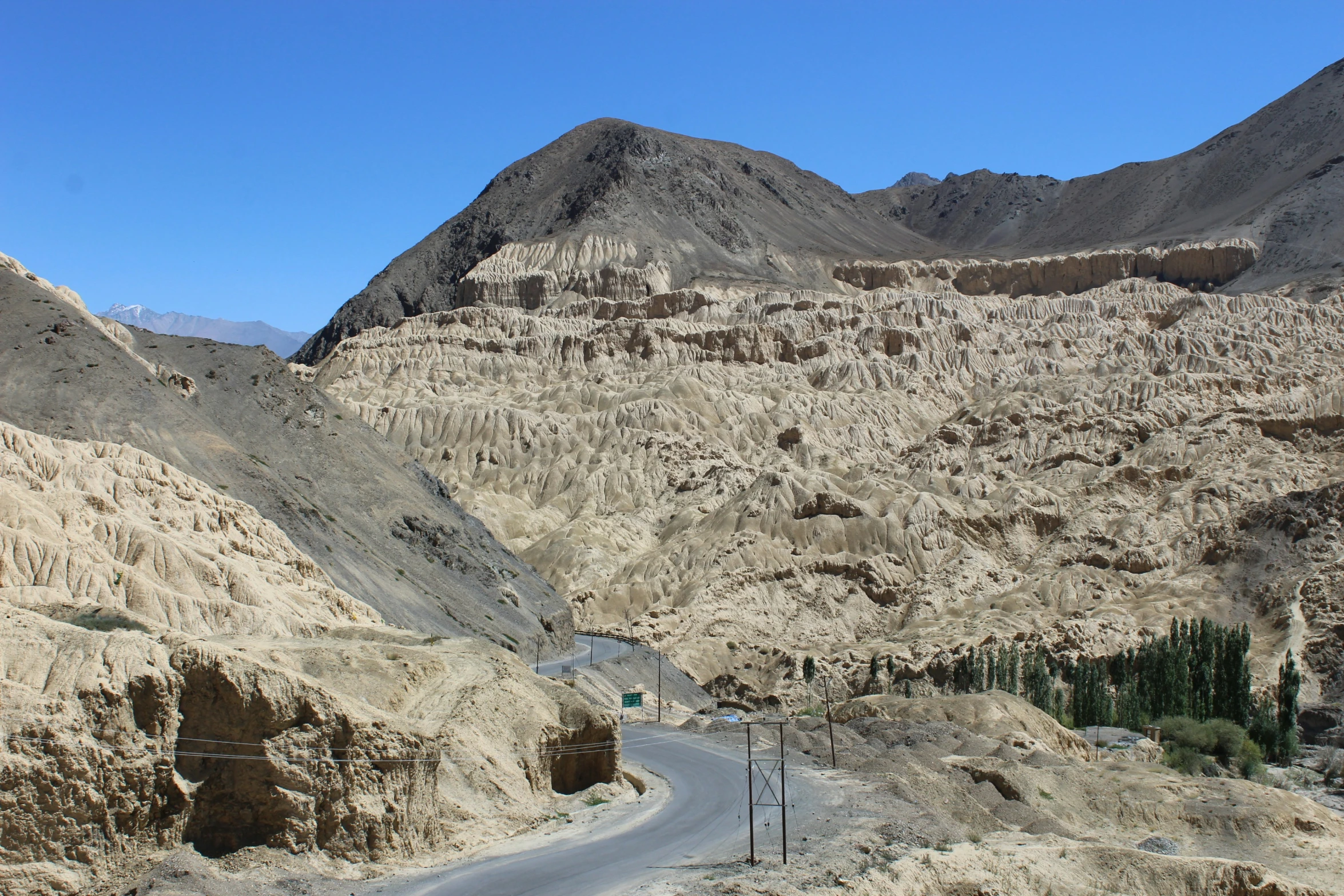 a winding road passing between two mountains