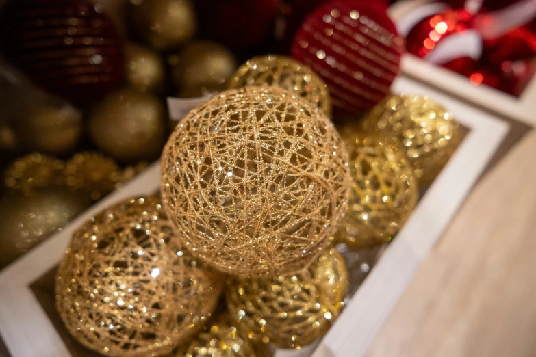 some red, gold and silver ornaments are shown together