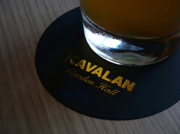 a glass filled with beer on top of a table