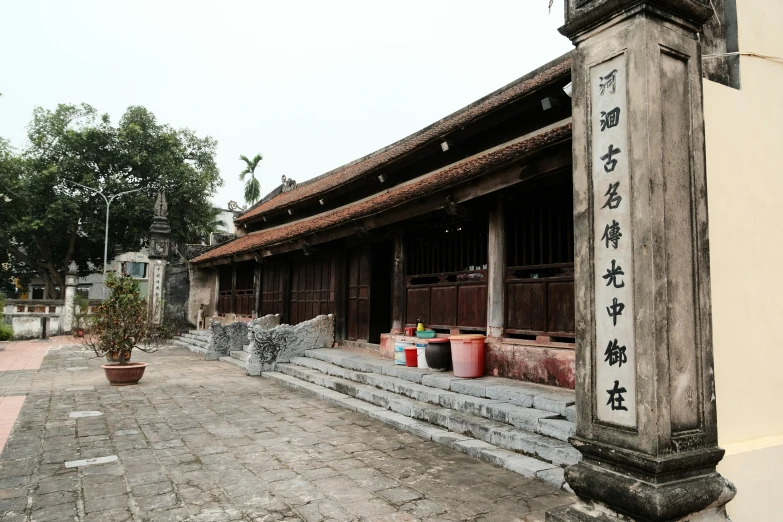 an old asian building with many pots outside