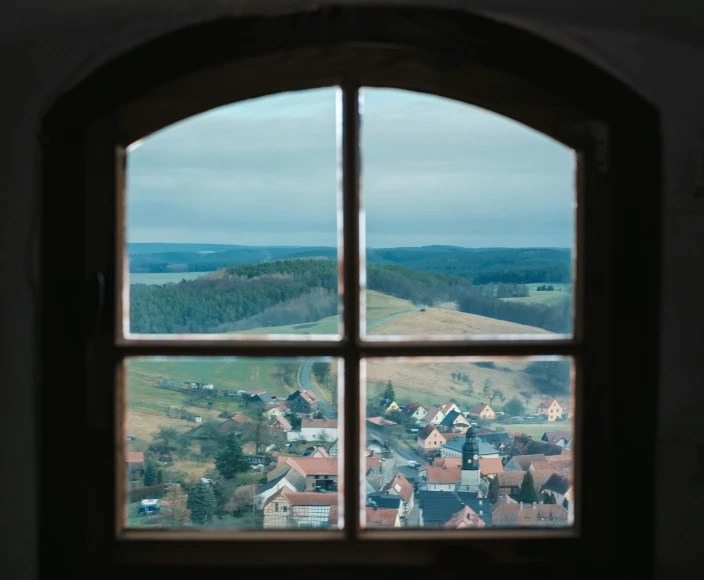 a view out a window at a town and mountains