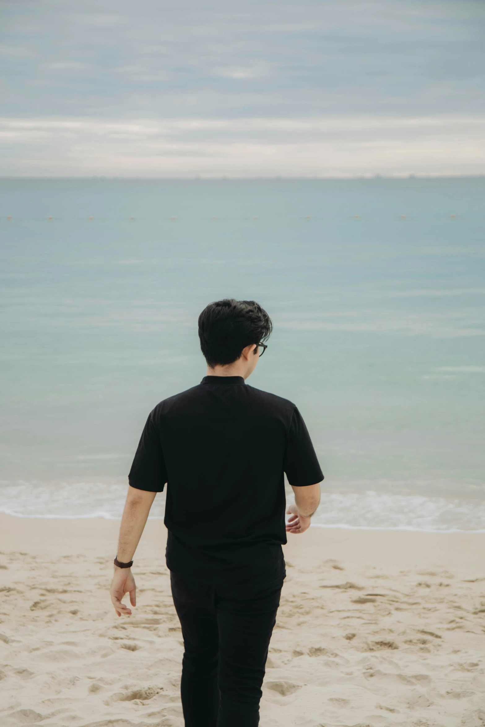 a man standing on the sand at the beach