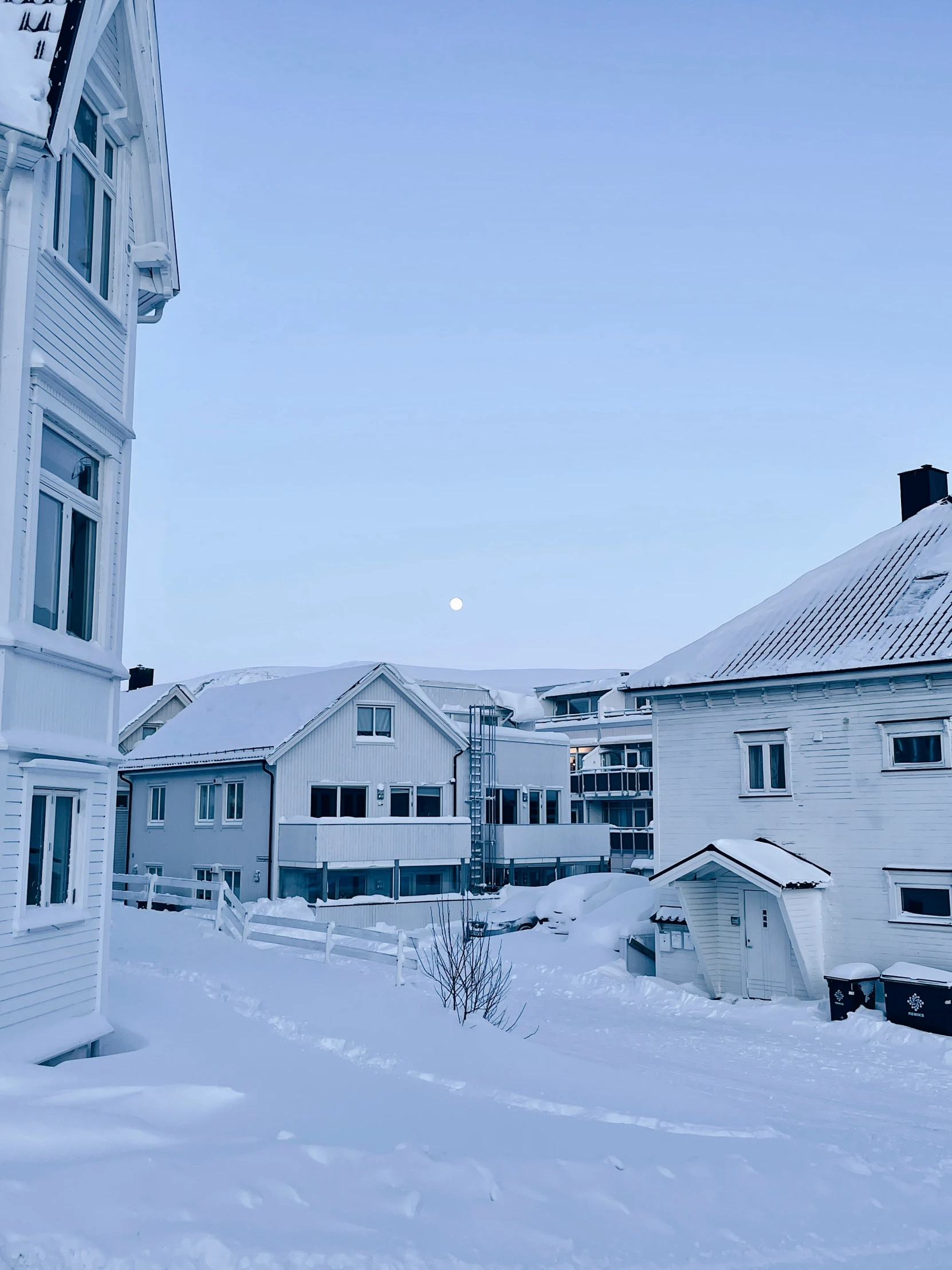 a street filled with snow near buildings