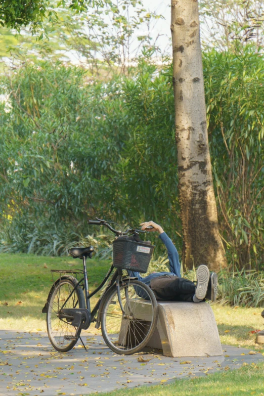 a man leaning over a bike on top of a concrete bench